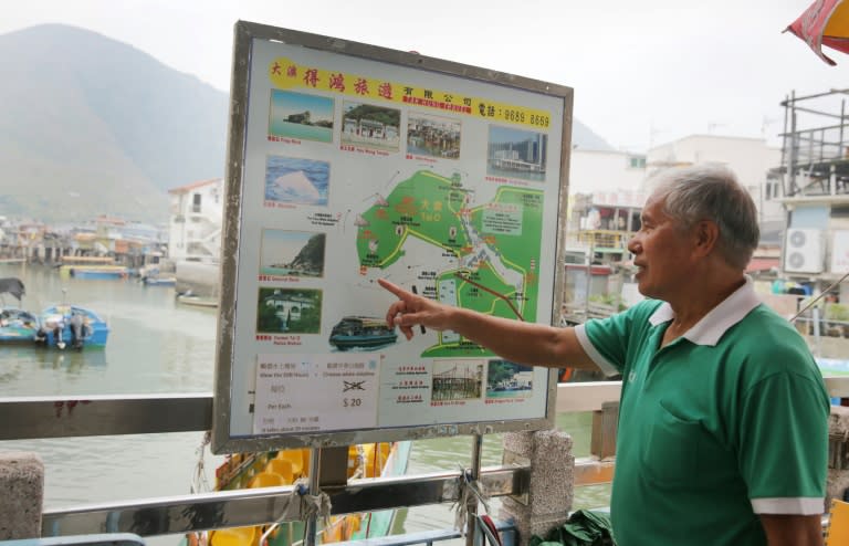 Tour boat operator Wong Yung-kan points out the locations where Hong Kong's famous pink dolphins can be found in the waters around Tai O