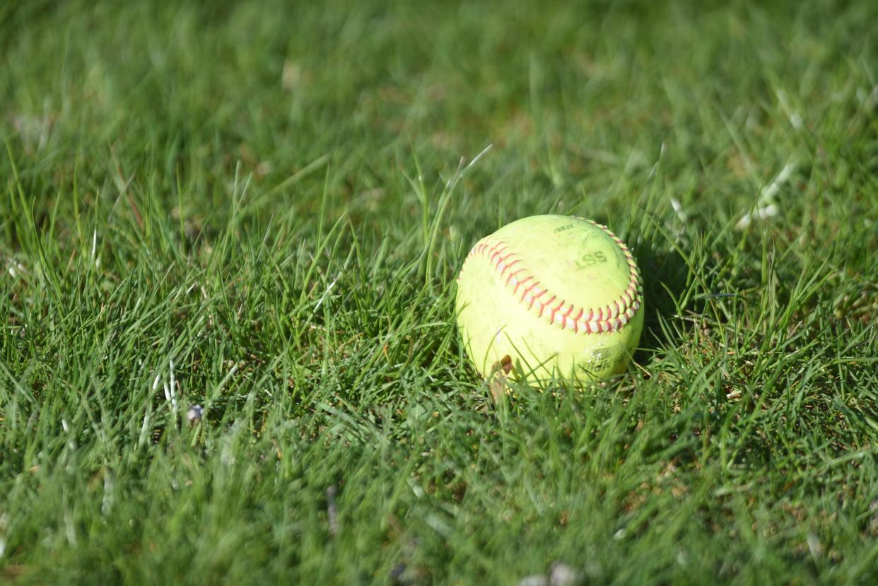 A softball sits on the grass at Armada High School on Tuesday, April 16, 2024.