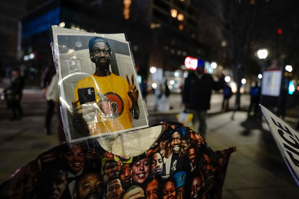 A photograph of Nichols is displayed at a rally in Atlanta above a T-shirt printed with the images of Black victims of police violence.