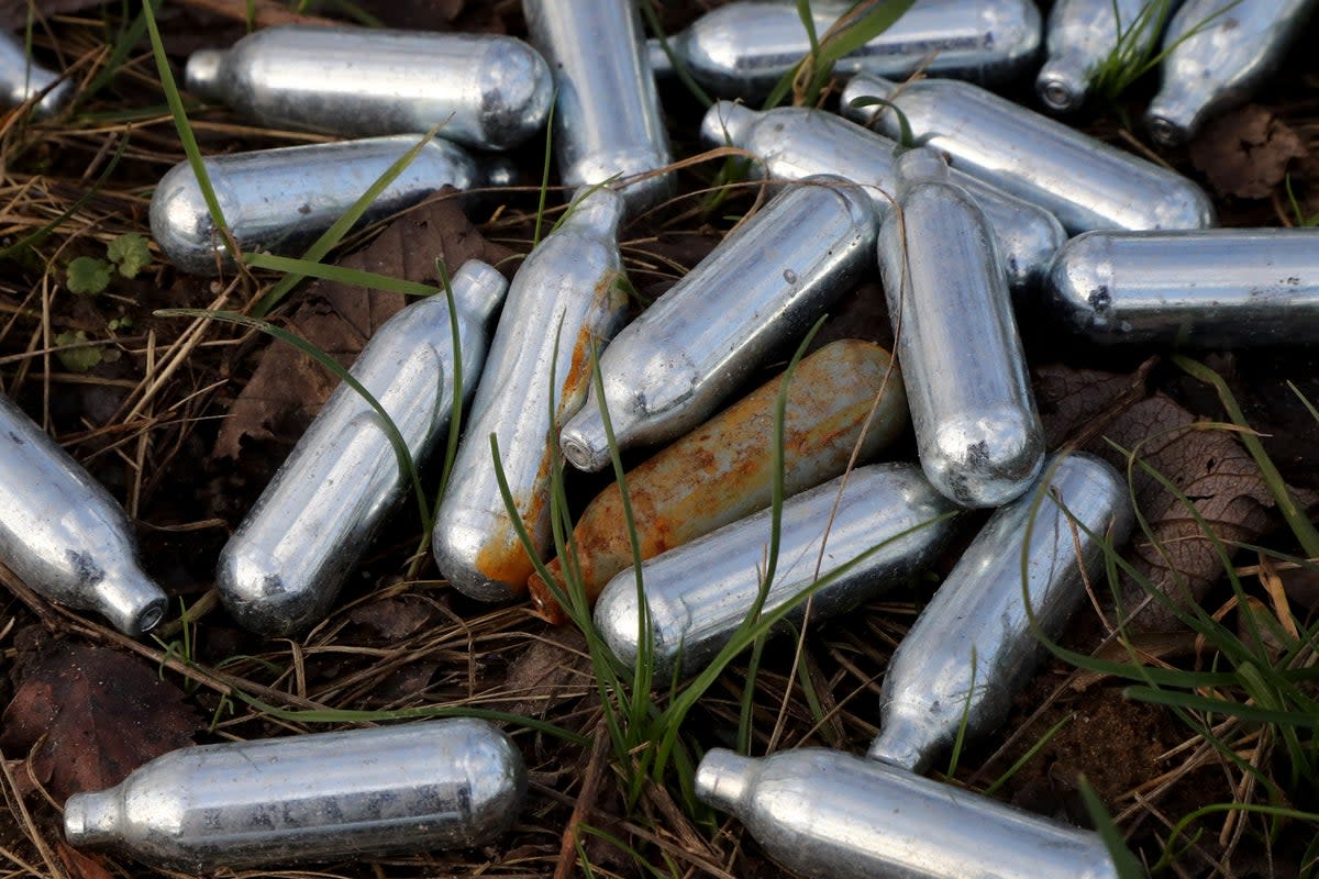 Canisters of nitrous oxide, or laughing gas, lie discarded by the side of a road near Ebbsfleet, Kent (Gareth Fuller/PA) (PA Archive)