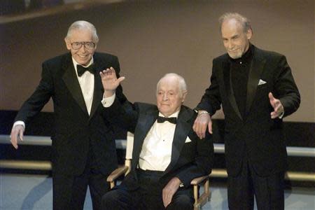 Milton Berle (L), Bob Hope and Sid Caesar wave to the audience after being introduced on stage at the 50th Anniversay Emmy Awards in Los Angeles in this September 13 1998 file photo. REUTERS/Gary Hershorn/Files