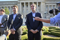 FILE - Ford President and CEO Jim Farley, left, and Kentucky Gov. Andy Beshear speak to reporters following the official announcement of Ford Motor Company along with SK Innovations in building two electric battery factories in Glendale, Ky., at the Kentucky State Capitol in Frankfort, Ky., Sept. 28, 2021. (AP Photo/Timothy D. Easley, File)