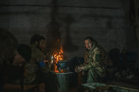 In this photo provided by Azov Special Forces Regiment of the Ukrainian National Guard Press Office, Ukrainian soldiers inside the ruined Azovstal steel plant take a rest in their shelter in Mariupol, Ukraine, May 7, 2022. For nearly three months, Azovstal’s garrison clung on, refusing to be winkled out from the tunnels and bunkers under the ruins of the labyrinthine mill. A Ukrainian soldier-photographer documented the events and sent them to the world. Now he is a prisoner of the Russians. His photos are his legacy.(Dmytro Kozatsky/Azov Special Forces Regiment of the Ukrainian National Guard Press Office via AP)