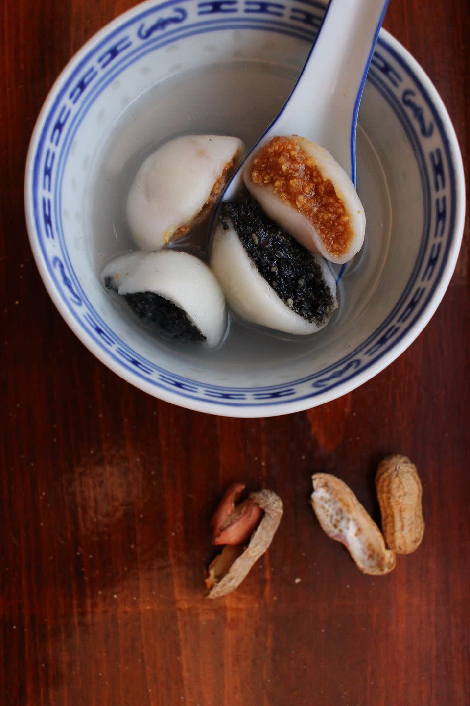 glutinous rice balls in a blue and white dish on a wooden background