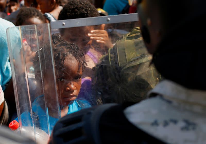 Migrants queue to get on buses after accepting an offer from the Mexican government to obtain humanitarian visas, in Tapachula