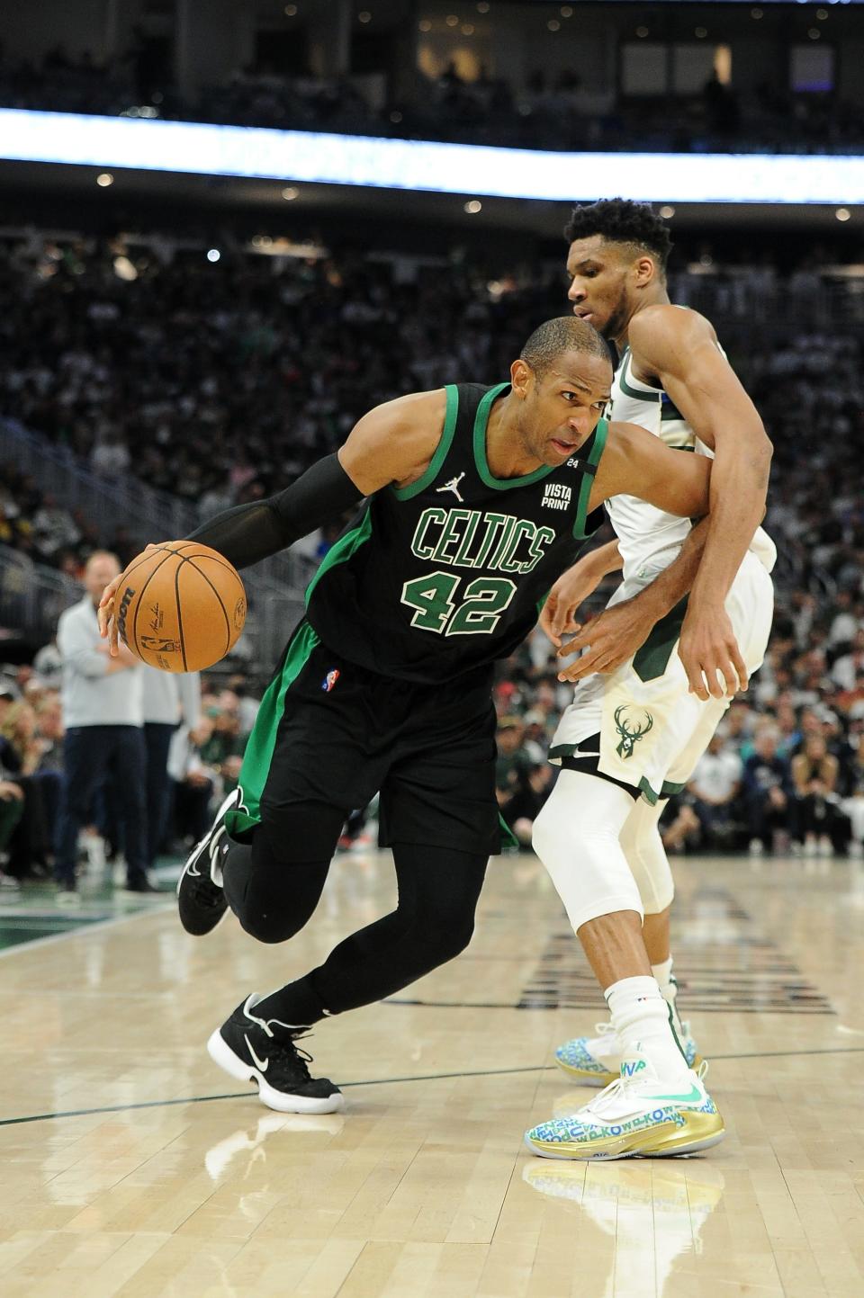 Al Horford drives around Giannis Antetokounmpo during Game 4 at Fiserv Forum.