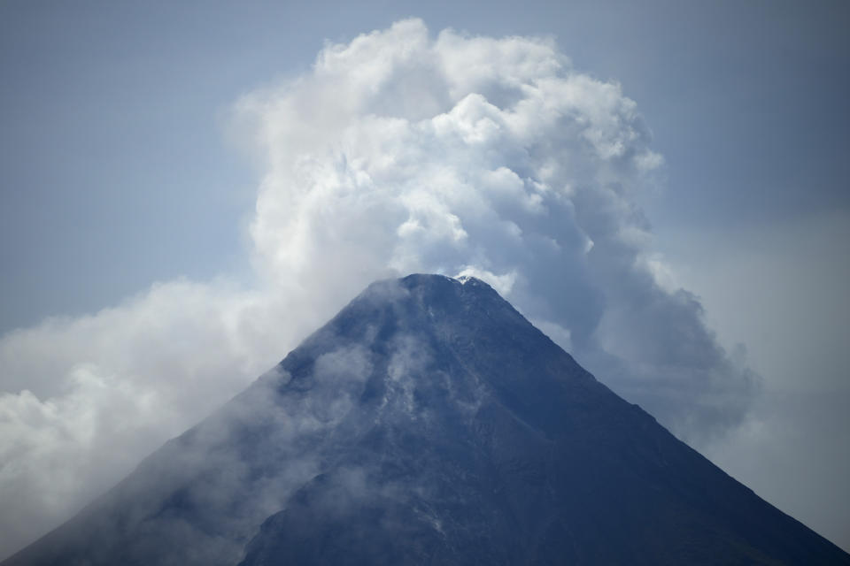 Mayon volcano spews hot emissions as seen from Malilipot, Albay province, northeastern Philippines, Thursday, June 15, 2023. Thousands of residents have left the mostly poor farming communities within a 6-kilometer (3.7-mile) radius of Mayon's crater in forced evacuations since volcanic activity spiked last week. (AP Photo/Aaron Favila)