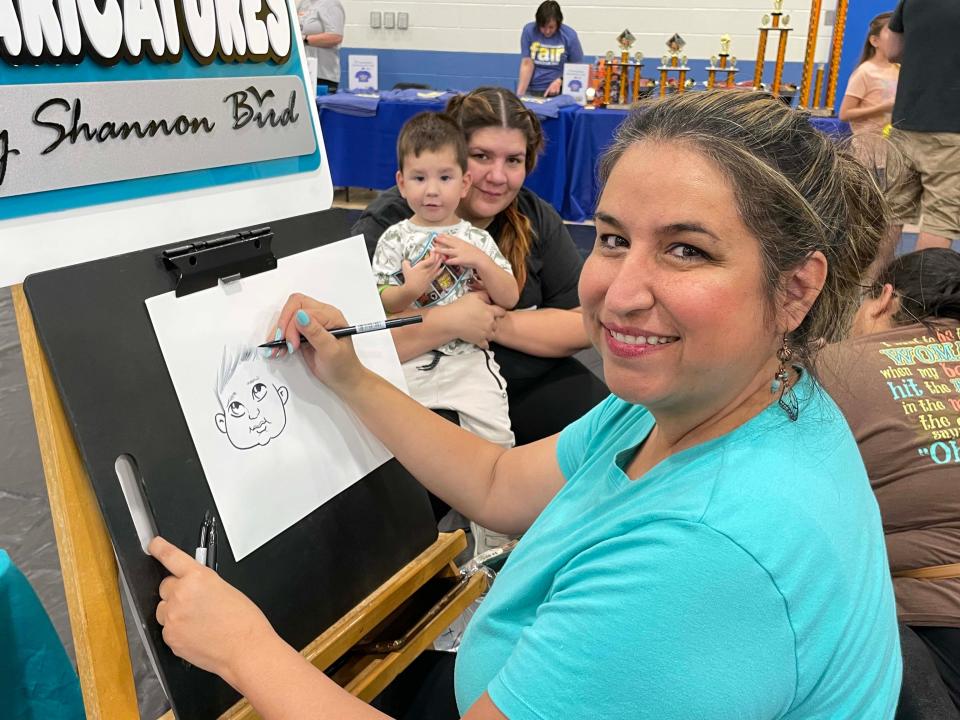 Shannon Bird with Dynamic Faces draws a character of little Eli Miller and his mom, Cami Miller.