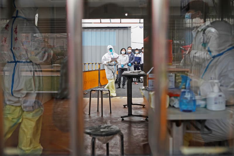 People wait in line to receive nucleic acid tests in Shanghai