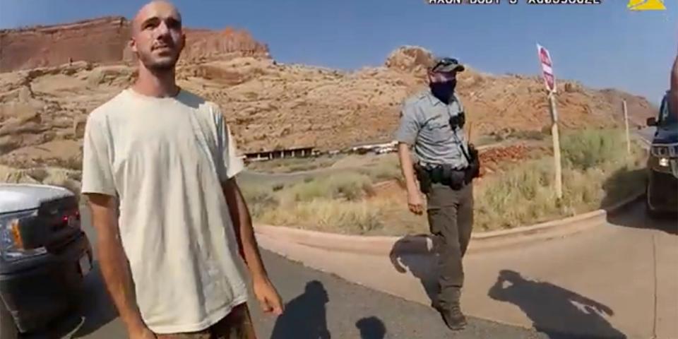 Brian Laundrie in the desert with a cop behind him