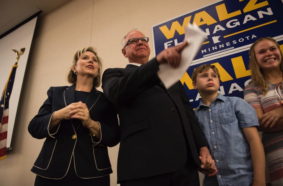 Rep. Tim Walz stands on stage at an election night party with his wife, Gwen Walz, son, Gus Walz, and daughter Hope Walz on August 14, 2018 in St Paul, Minnesota.