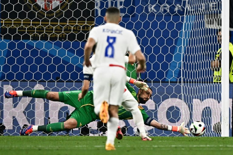 Gianluigi Donnarumma saves Luka Modric's penalty (GABRIEL BOUYS)