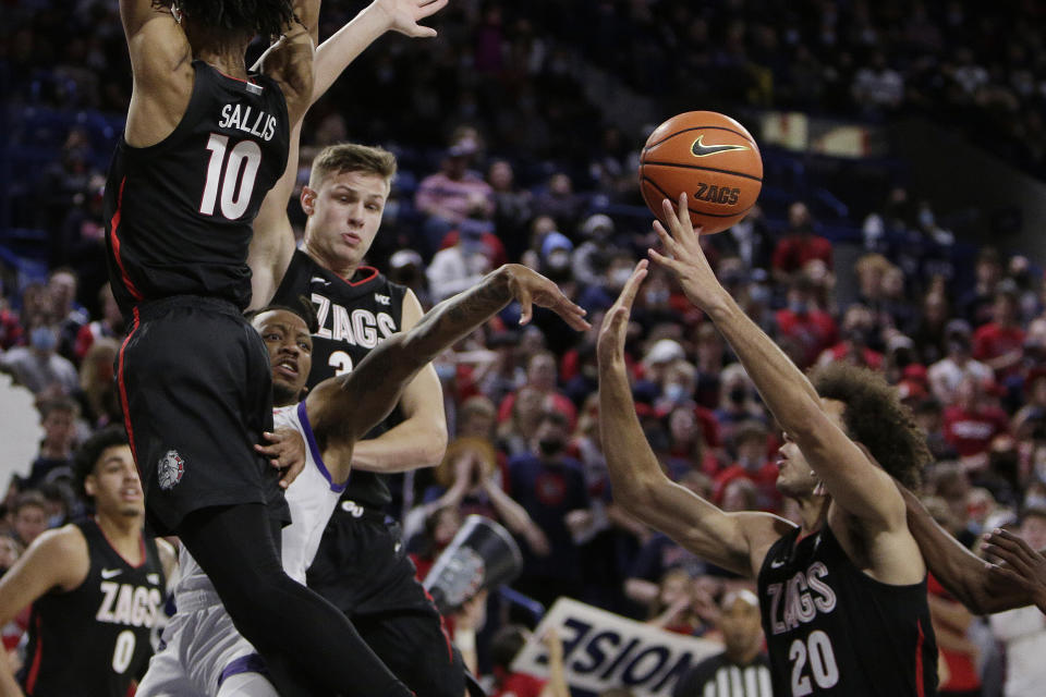 Alcorn State guard Justin Thomas, second from the left, passes the ball while pressured by Gonzaga guard Hunter Sallis, left, and forwards Kaden Perry, right, and Ben Gregg during the second half of an NCAA college basketball game, Monday, Nov. 15, 2021, in Spokane, Wash. (AP Photo/Young Kwak)