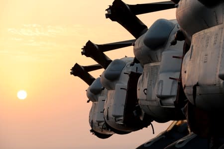 Wings of MV-22 Osprey aircrafts are seen during sunset on the flight deck of USS Boxer (LHD-4) in the Arabian Sea off Oman