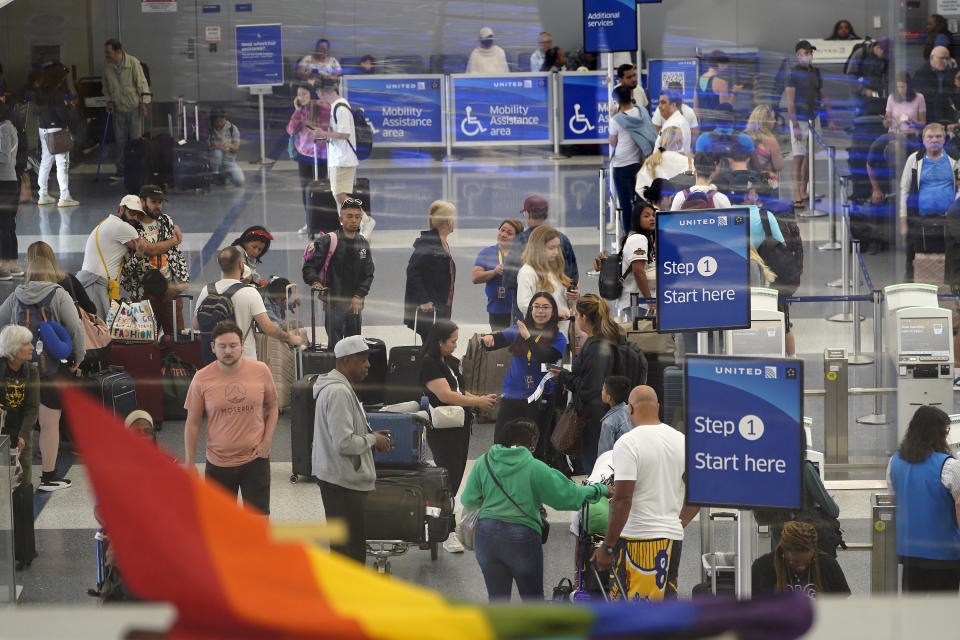 Travelers line up at the departure area check-in at the United Airlines terminal at Los Angeles International airport, Wednesday June 28, 2023, in Los Angeles. Travelers waited out widespread delays at U.S. airports on Tuesday, an ominous sign heading into the long July 4 holiday weekend, which is shaping up as the biggest test yet for airlines that are struggling to keep up with surging numbers of passengers. (AP Photo/Damian Dovarganes)