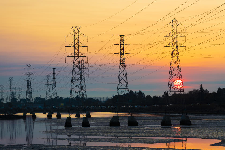 Power transmission tower is silhouetted by the rising sun in Burlingame, California on October 26, 2019. Potentially historic windstorm coming to the San Francisco Bay Area may prompt Pacific Gas and Electric Company, PG&E to shutoff power to as many as 2 million people to lower devastating wildfire risk. (Photo by Yichuan Cao/NurPhoto via Getty Images)