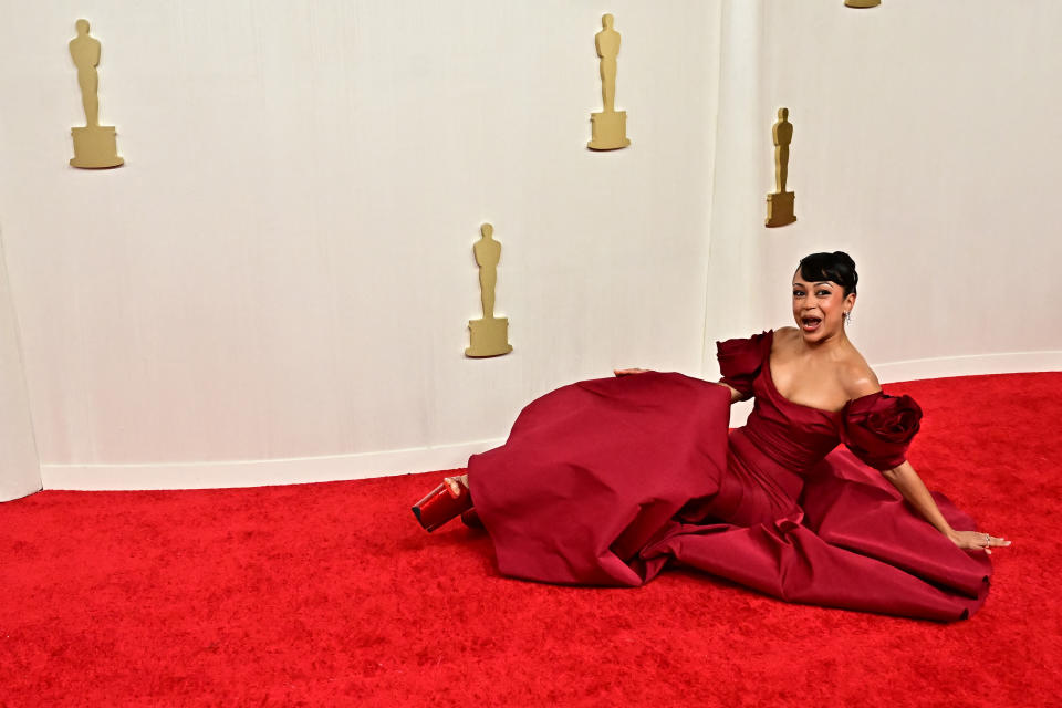 Liza Koshy attends the 96th Annual Academy Awards, red carpet, red carpet falls, pleaser platform heels, red pleaser pumps, 7-inch stilettos, liza koshy oscars fall, liza koshy oscars red carpet, marchesa gown