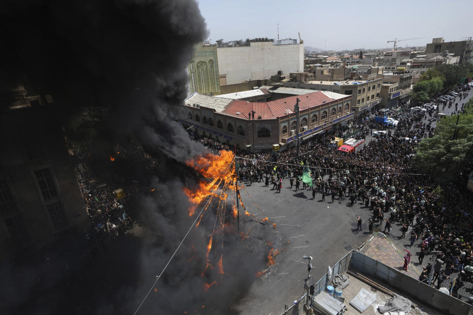 Shiite Muslims burn a tent during a re-enactment of the battle of Karbala in 7th century in present-day Iraq, during Ashoura rituals, Friday, July 28, 2023, in Tehran, Iran. Millions of Shiite Muslims in Iran, Afghanistan, Pakistan and around the world on Friday commemorated Ashoura, a remembrance of the 7th-century martyrdom of Imam Hussein, that gave birth to their faith. (AP Photo/Vahid Salemi)