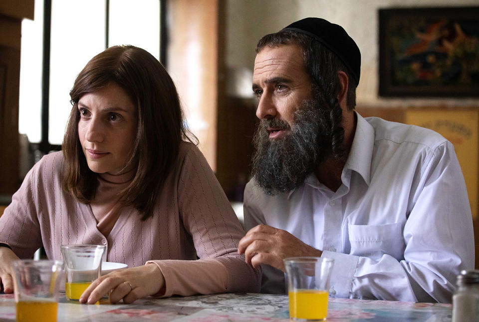 Still from the show Shtisel of an Orthodox Jewish woman and man sitting at a table