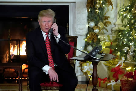 U.S. President Donald Trump participates in NORAD Santa tracker phone calls from the White House in Washington, U.S. December 24, 2018. REUTERS/Jonathan Ernst