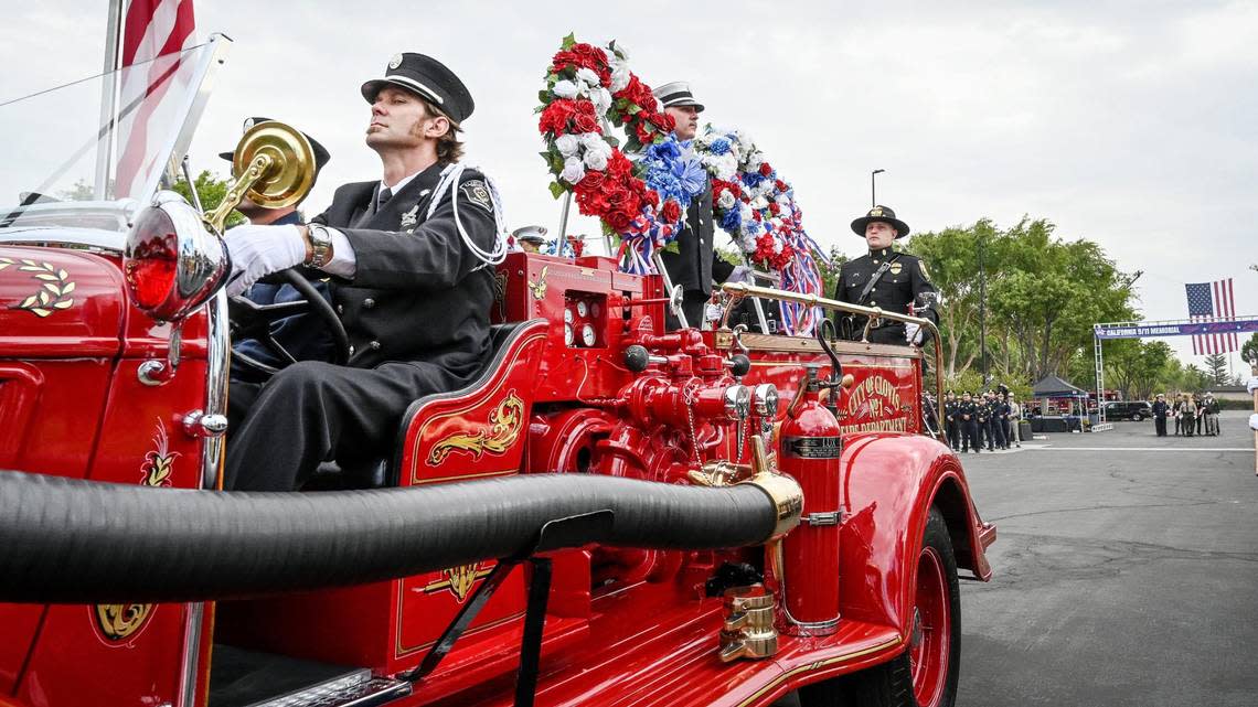 An antique fire truck from the Clovis Fire Department arrives with wreaths to be laid out during the 21st anniversary September 11 Memorial Ceremony at the California 9/11 Memorial in Clovis on Sunday, Sept. 11, 2022.