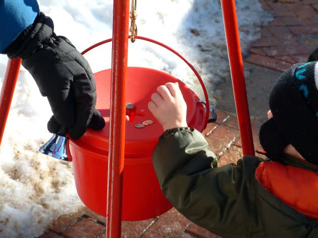 Boy donates coins during holiday season (Photo: jsmith via Getty Images)