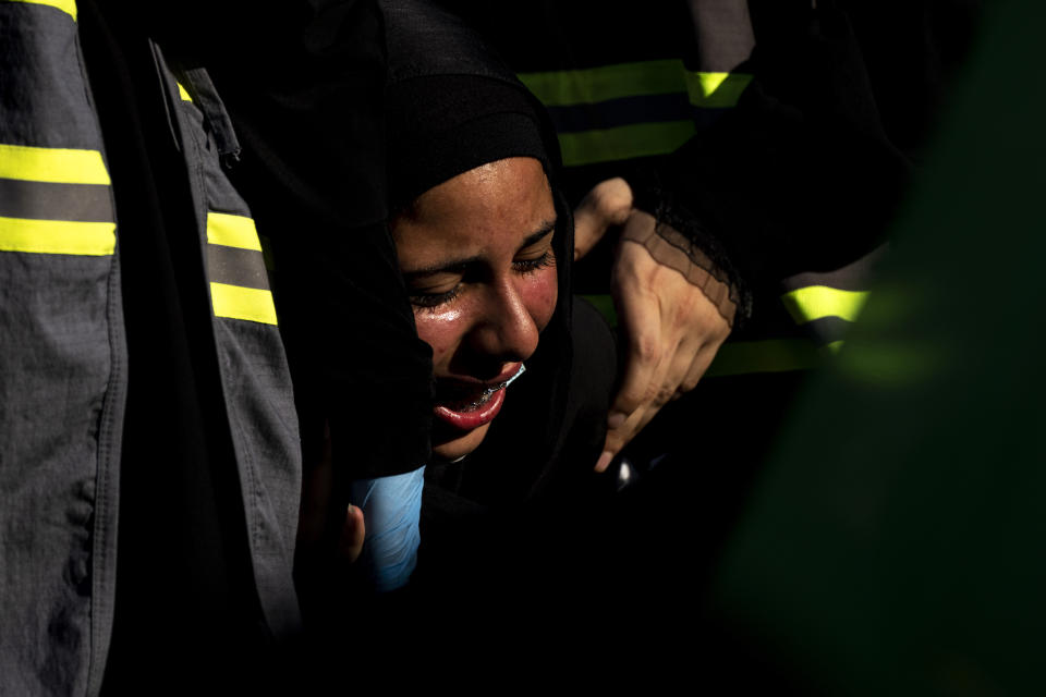 A Lebanese Shiite supporter of Hezbollah cries as she listens to the story of Imam Hussein, during activities marking the holy day of Ashoura, in southern Beirut, Lebanon, Thursday, Aug. 19, 2021. The leader of the militant Hezbollah group Sayyed Hassan Nasrallah said Thursday that the first Iranian fuel tanker will sail toward Lebanon "within hours" warning Israel and the United States not to intercept it. (AP Photo/ Hassan Ammar)