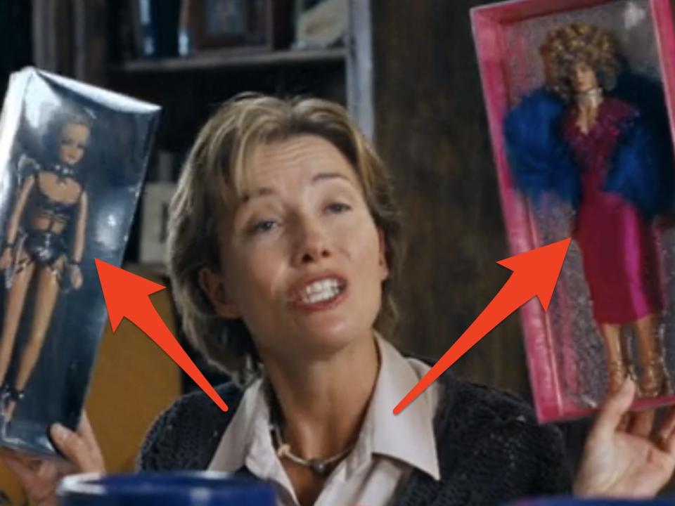 arrows pointing to emma thompson holding ken dolls in love actually