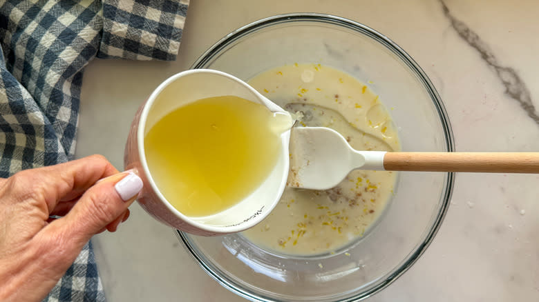 hand mixing muffin batter in bowl