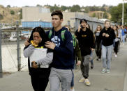 Students are escorted outside of Saugus High School after reports of a shooting on Thursday, Nov. 14, 2019, in Santa Clarita, Calif. (AP Photo/Marcio Jose Sanchez)