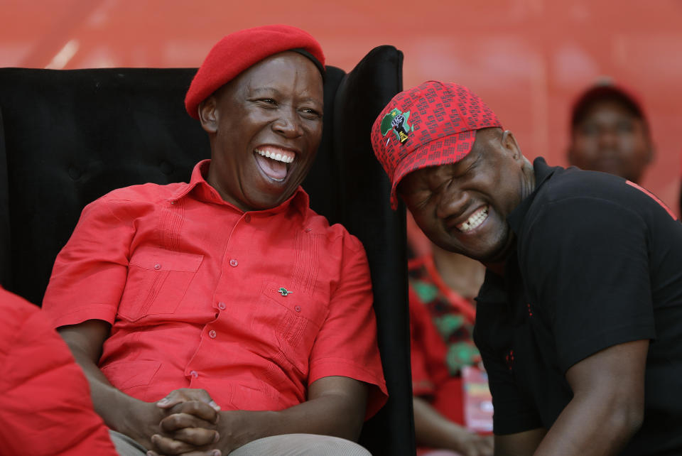 Leader of the Economic Freedom Fighters (EFF) party, Julius Malema, shares a light moment with party member during his election rally at Orlando Stadium in Soweto, South Africa, Sunday, May 5, 2019. Campaign rallies for South Africa’s upcoming election have reached a climax Sunday with mass rallies by the ruling party and one of its most potent challengers. (AP Photo/Themba Hadebe)