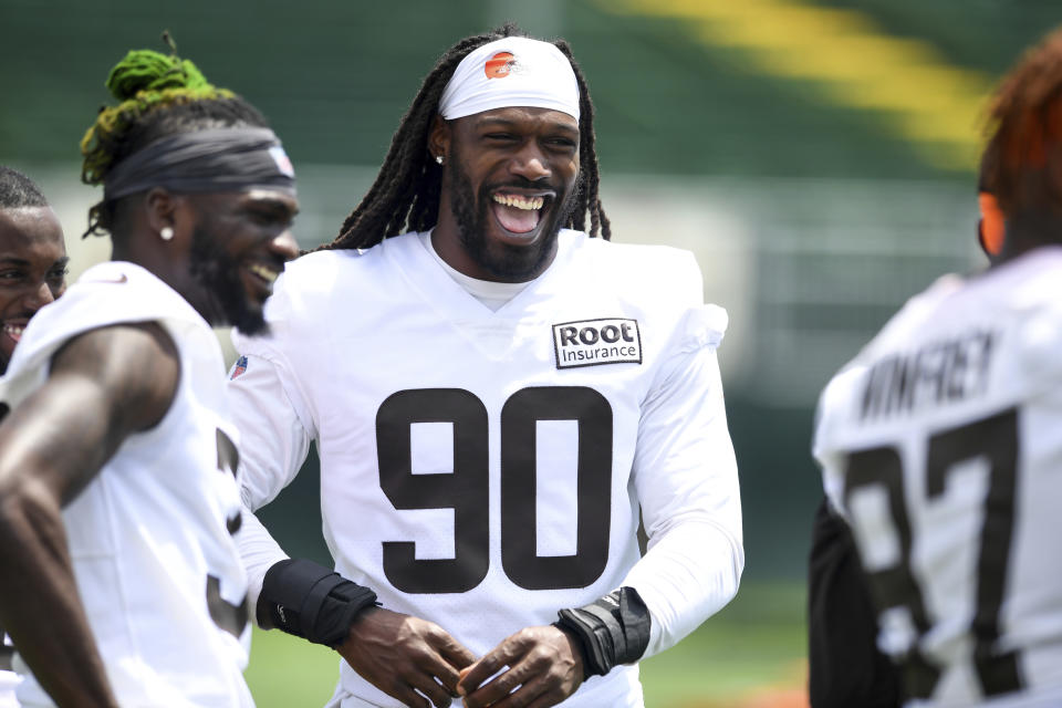 Cleveland Browns defensive end Jadeveon Clowney laughs with teammates during the NFL football team's training camp, Thursday, July 28, 2022, in Berea, Ohio. (AP Photo/Nick Cammett)