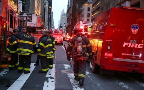 Emergency crews at the site of the Trump Tower fire - Credit: Reuters