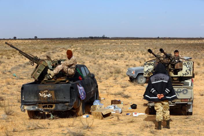 Fighters from the Fajr Libya (Libya Dawn) militia during clashes with forces loyal to Libya's internationally recognised government near the Wetia military air base, some 170 kilometres west of the capital Tripoli on January 5, 2015 (AFP Photo/Mahmud Turkia)
