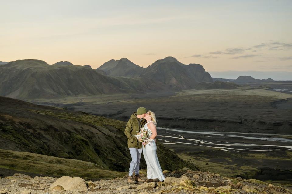 A bride and groom kiss at sunset in Iceland