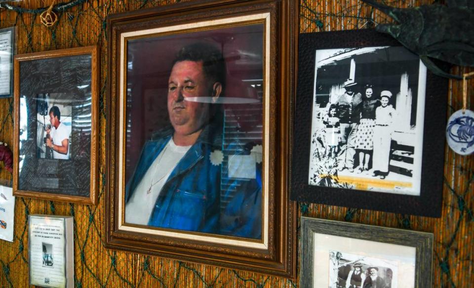 Benny Hudson’s portrait hangs on the wall behind the counter at Benny Hudson Seafood off Squire Pope Road on Hilton Head Island. The black and white photo to the right shows a young Hudson wearing white with a hat.