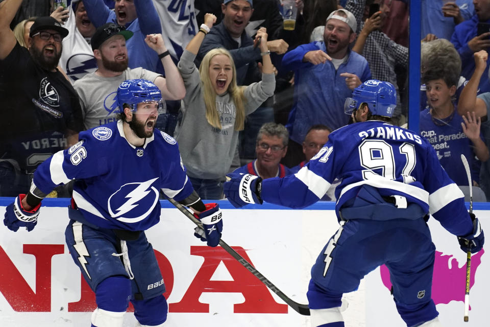 Tampa Bay Lightning right wing Nikita Kucherov, left, celebrates after scoring a goal against the New York Rangers with teammate center Steven Stamkos (91) during the second period in Game 4 of the NHL Hockey Stanley Cup playoffs Eastern Conference finals Tuesday, June 7, 2022, in Tampa, Fla. (AP Photo/Chris O'Meara)