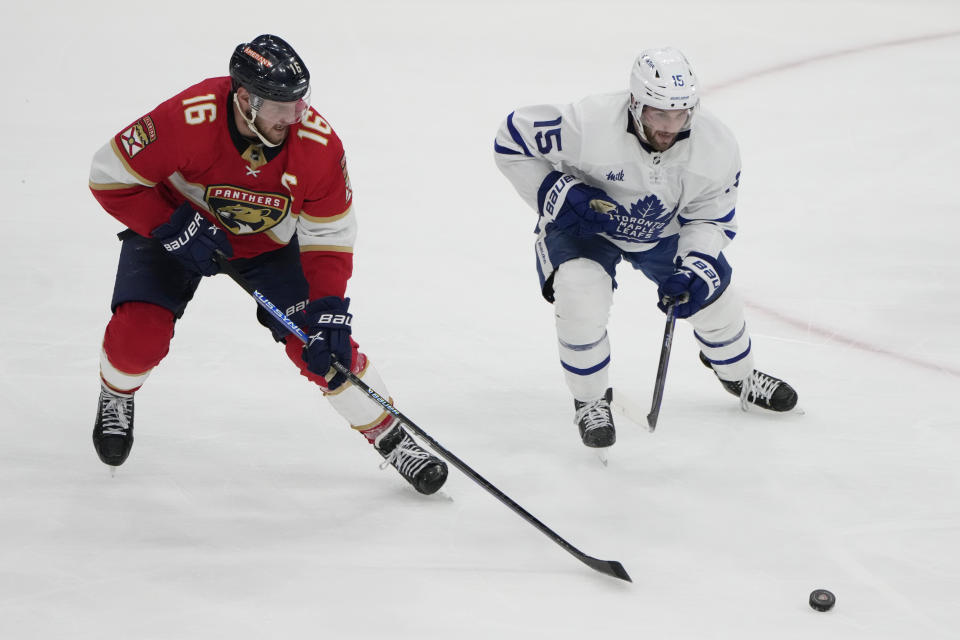 Florida Panthers center Aleksander Barkov (16) and Toronto Maple Leafs center Alexander Kerfoot (15) chase the puck during the third period of Game 4 of an NHL hockey Stanley Cup second-round playoff series Wednesday, May 10, 2023, in Sunrise, Fla. (AP Photo/Lynne Sladky)