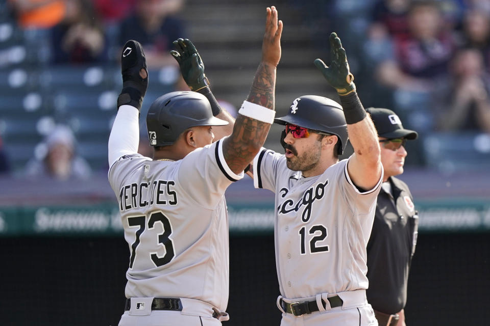 Chicago White Sox's Adam Eaton (12) and Yermin Mercedes (73) celebrate after Eaton hit a two-run home run in the eighth inning of the first baseball game of a doubleheader against the Cleveland Indians, Monday, May 31, 2021, in Cleveland. (AP Photo/Tony Dejak)