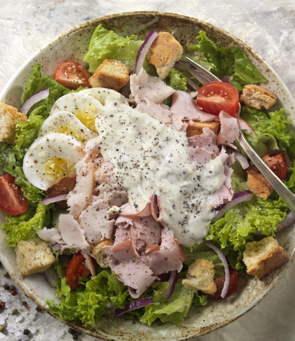 A chef's salad coated with ranch dressing