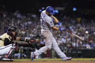 Los Angeles Dodgers' Steven Souza connects for a home run next to Arizona Diamondbacks catcher Carson Kelly during the eighth inning of a baseball game Friday, June 18, 2021, in Phoenix. (AP Photo/Ross D. Franklin)