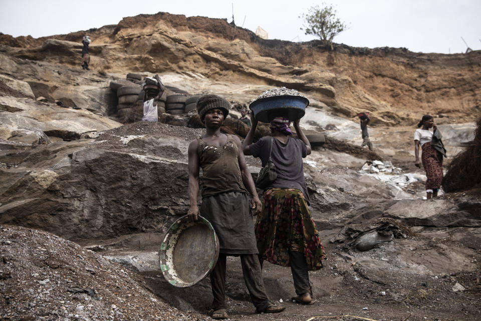 Women work in a Pissy granite mine in Ouagadougou, Burkina Faso, Monday April 25, 2022. he influx of people displaced by the country's rapidly rising Islamic violence is causing competition among the approximately 3,000 people working at the granite mine. At least 500 displaced people started working at the mine last year making it harder for the original miners to earn a living, said Abiba Tiemtore, head of the site. (AP Photo/Sophie Garcia)