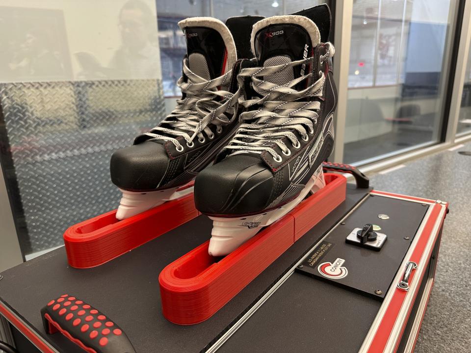 Skates sit in a Conicity Technologies’ grinding machine designed to remove tiny burrs from the metal blades, at the Washington Capitals NHL hockey team practice facility in Arlington, Virginia, Nov. 28, 2023. Dr. Bill Shaffer and son Luke, who come from a metal-cutting background, designed and built the machine they say can dramatically reduce the cutting qualities of skate blades while also keeping them sharp and allowing for better gliding along ice. The death of American hockey player Adam Johnson from a skate cut to the neck during a game in England has led to plenty of talk about how to prevent such injuries in the fast-paced sport, including a new neck laceration protection mandate in the U.S.(AP Photo/Stephen Whyno)