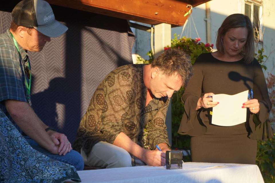 Randy Bishop signed the deed to 98 acres of land on Governors Point over to the Whatcom Land Trust on Wednesday, Sept. 13, at a public signing ceremony at Boundary Bay Brewery in Bellingham, Wash.