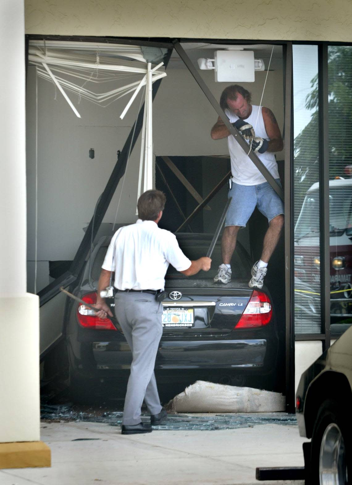 In this file photo from Sept. 28, 2004, a Toyota Camry is prepared to be taken out of Physiotherapy Associates on University Drive after a driver tried to park next door at a UPS Store. The driver told police he tried to hit the brakes but the car did not stop.