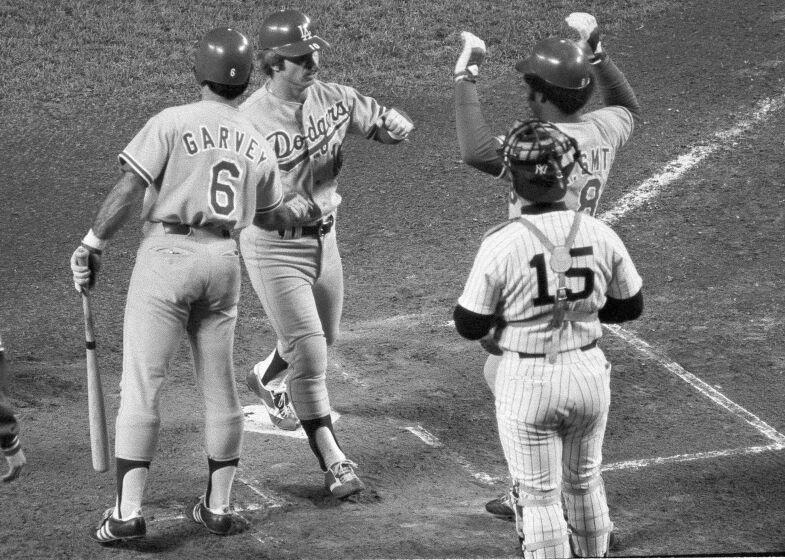 Dodgers'  Ron Cey is congratulated by teammates Steve Garvey, left, and Reggie Smith.