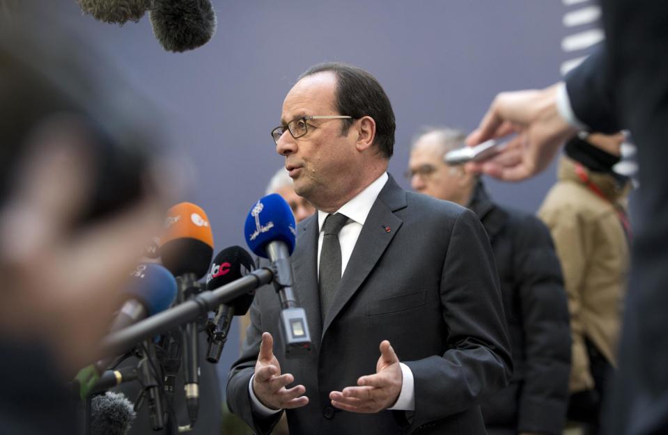 French President Francois Hollande, center, speaks with the media as he arrives for an EU Summit in Brussels on Thursday, Dec. 15, 2016. European Union leaders meet Thursday in Brussels to discuss defense, migration, the conflict in Syria and Britain's plans to leave the bloc. (AP Photo/Virginia Mayo)