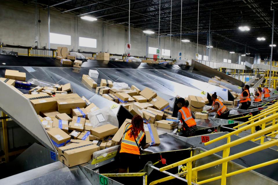 Workers in the Amazon Air Rockford hub sort packages during the Prime Day sales event on Tuesday, July 11, 2023.