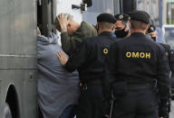 Police officers detain protesters during a rally against the removal of opposition candidates from the presidential elections in Minsk, Belarus, Tuesday July 14, 2020. Election authorities in Belarus on Tuesday barred two main rivals of authoritarian leader Alexander Lukashenko from running in this summer's presidential election. (AP Photo/Sergei Grits)