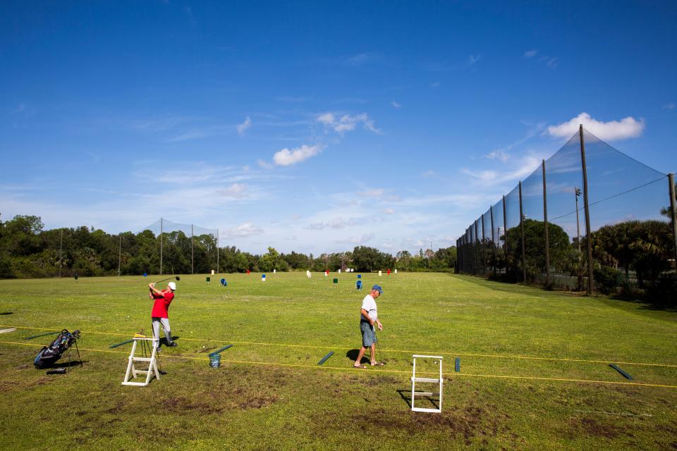 Keith Copenhaver, left, and Randy Neustifter hit balls together at Golf Coast Driving Range in Estero on Monday, Nov. 5, 2018. 